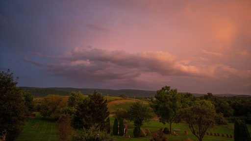 Gorgeous pink and blue sky at sunset over rolling hills