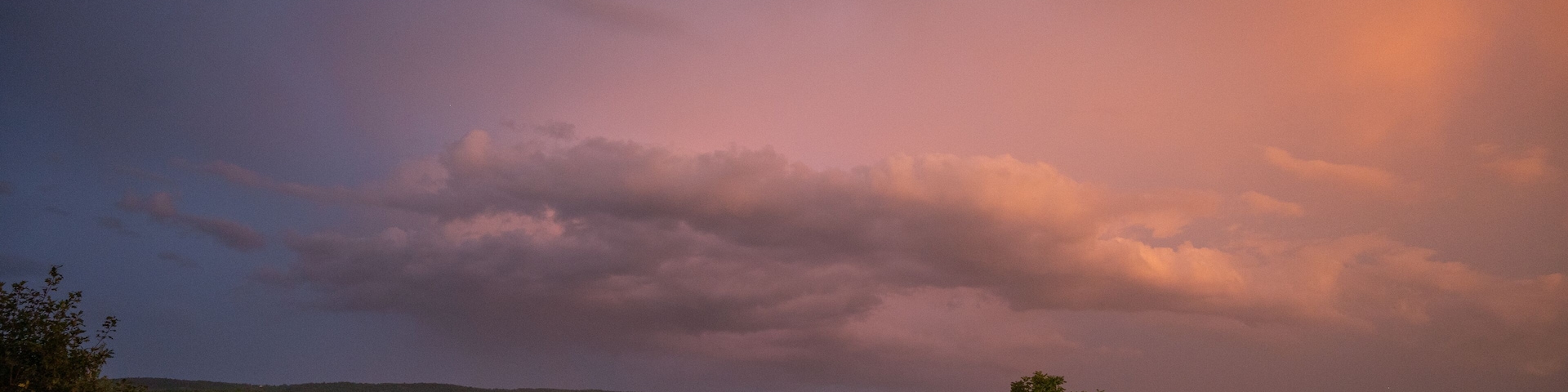 Gorgeous pink and blue sky at sunset over rolling hills