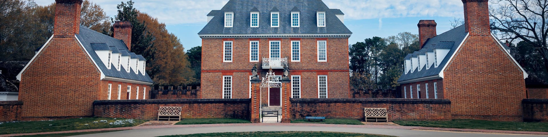 A large brick building with a central tower and two symmetrical wings.