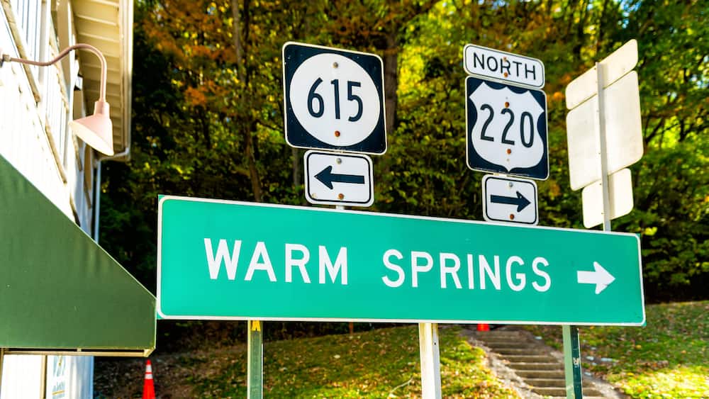 Road signs for 615 and 220 North, and a sign for Warm Springs.