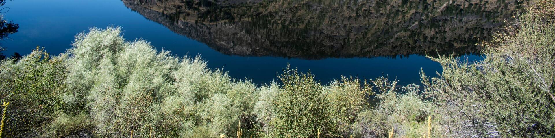 Mountain scene reflected on the pristine Blue Lake in Eastern Washington at the Sinlahekin Wildlife Area near Tonasket; Tonasket, Okanogan County, Washington, United States of America