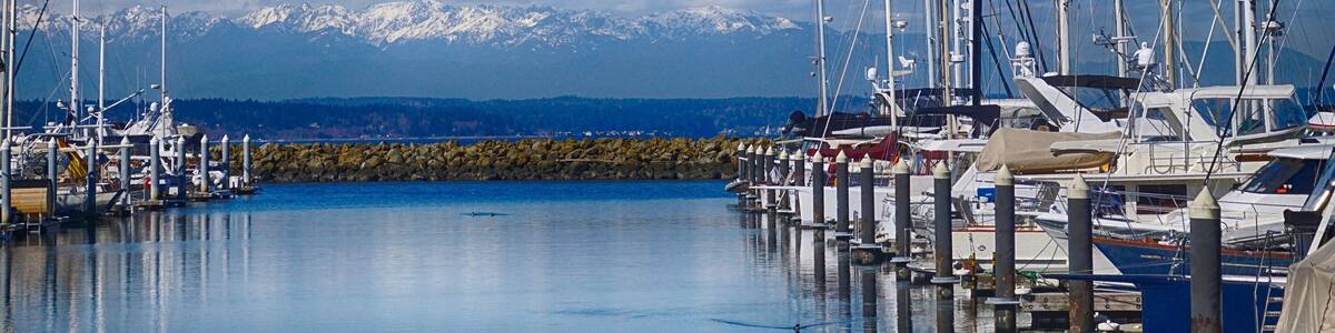 Reflections of sailboats in marina