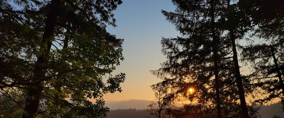 Sunset with wildfire smoke at Clear Lake in Yelm Washington state