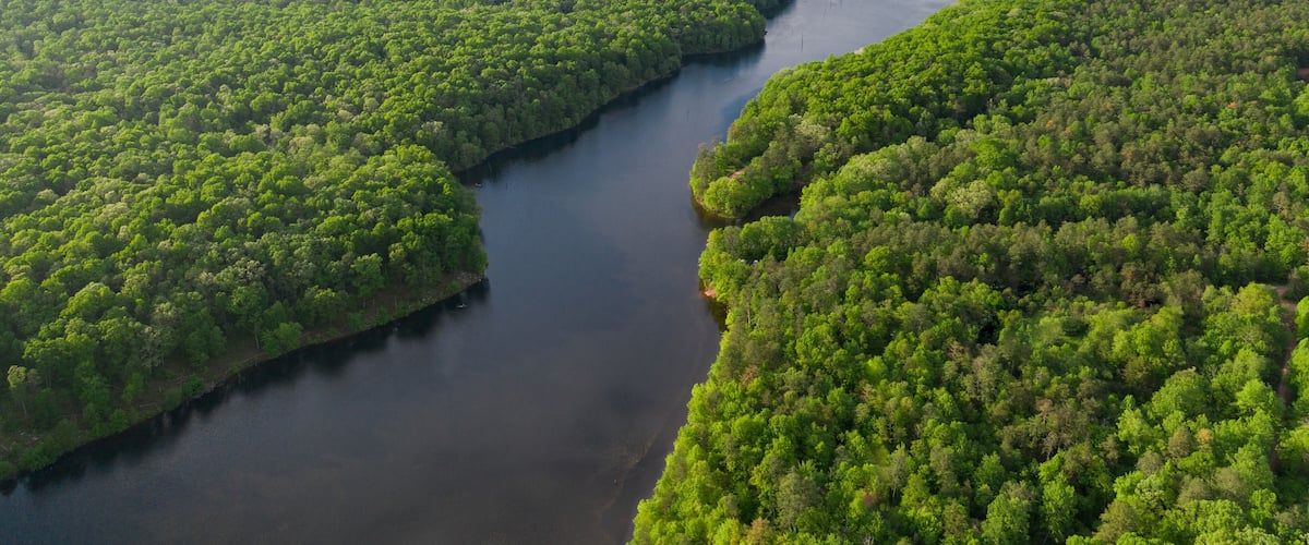 Aerials Over Big Lake in Forest Covered Hills