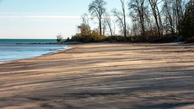 The silent beach scene, now covered with the streaking shadows from the afternoon lowering sun, at Harrington Beach State Park, Belgium, Wisconsin in early November