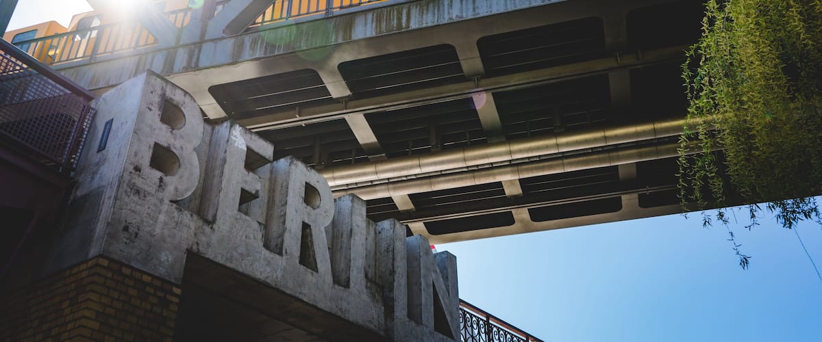 A train on a bridge with the word "BERLIN" on the side.