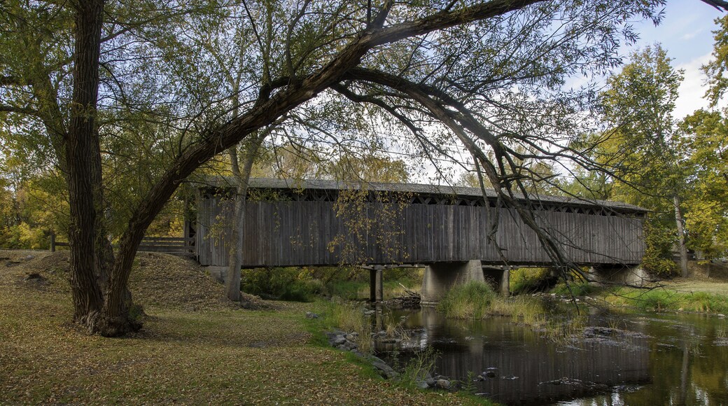 Photograph of a historical covered bridge crossing a southern Wisconsin river near Cedarburg