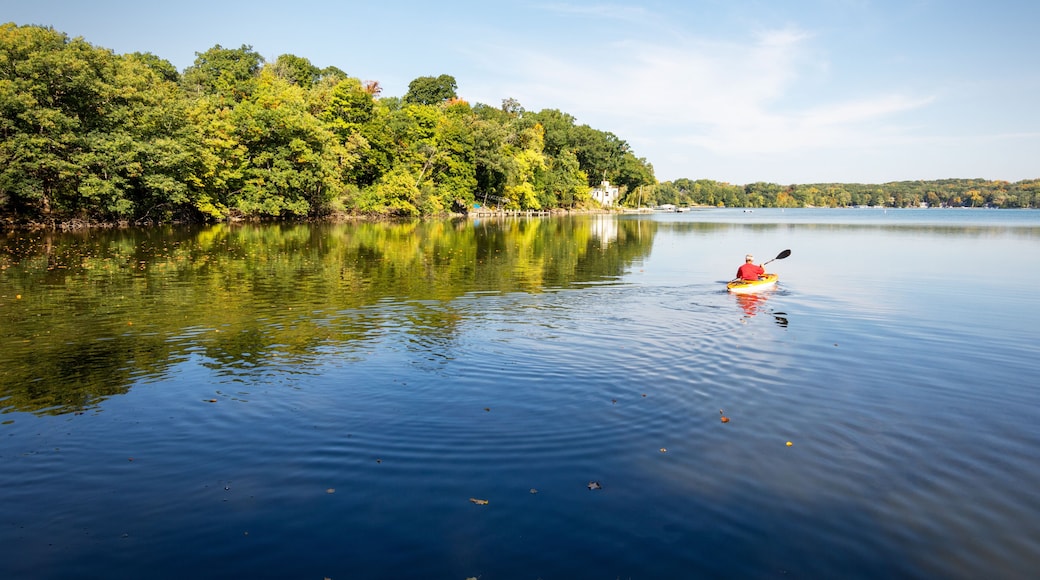 A Kayaker takes to the water on a warm October morning on a lake in Wisconsin.