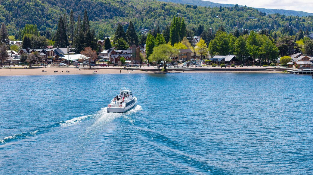A tourist boat sails on Lake Lacar, with the city of San Martin de los Andes in the background.