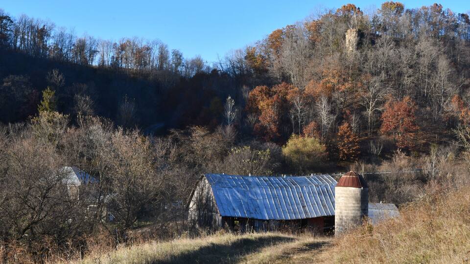 A homestead farm in the Driftless Area of Southwest Wisconsin, shown in the fall with oak trees and an old tobacco barn.
