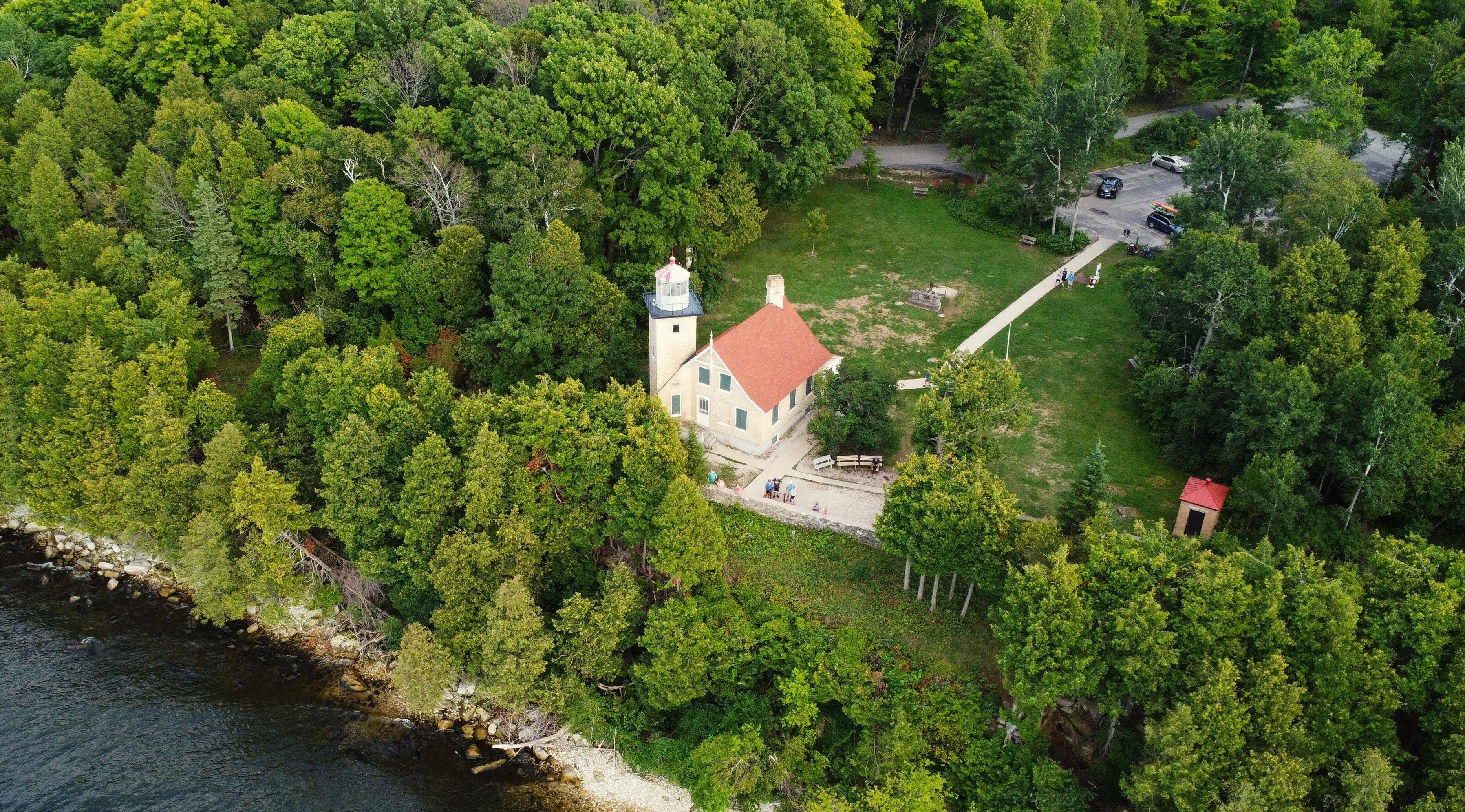 Aerial lighthouse photo over lake Michigan in Fish Creek Wisconsin.
