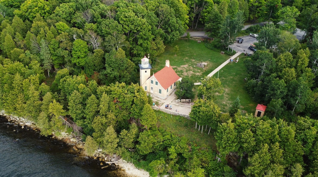 Aerial lighthouse photo over lake Michigan in Fish Creek Wisconsin.
