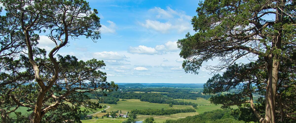 Sunny Summer day landscape of lush green fields and forests as seen from the top of Gibraltar Rock near Lodi, Wisconsin.