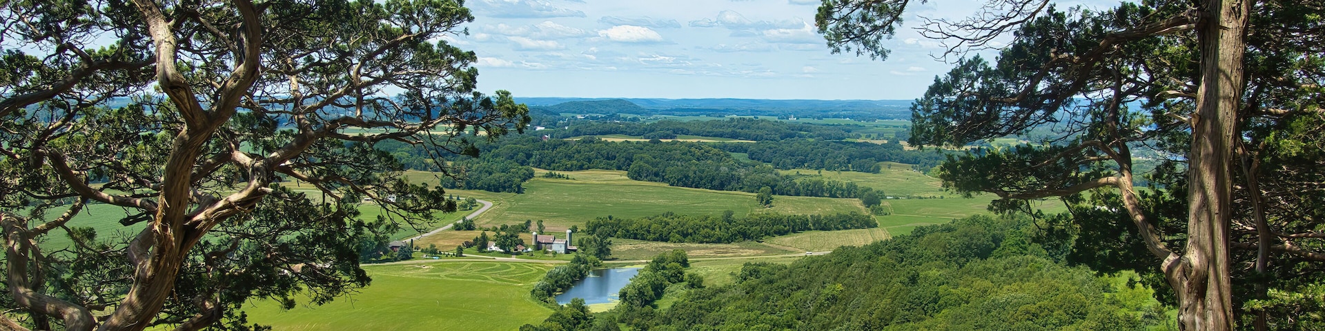 Sunny Summer day landscape of lush green fields and forests as seen from the top of Gibraltar Rock near Lodi, Wisconsin.