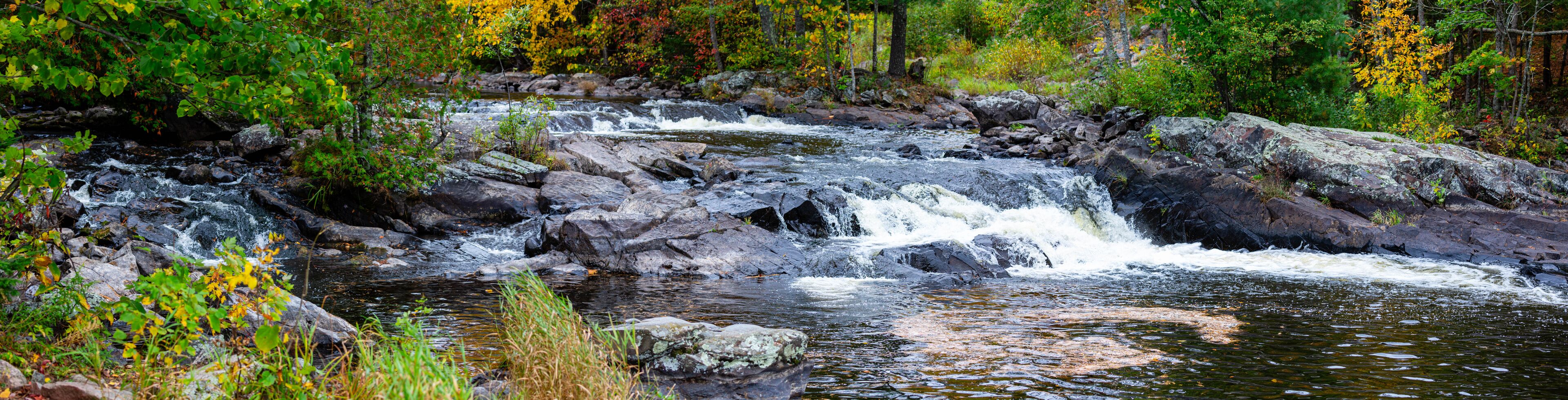 Waterfalls flowing into Lake of the Falls in Mercer, Wisconsin in September
