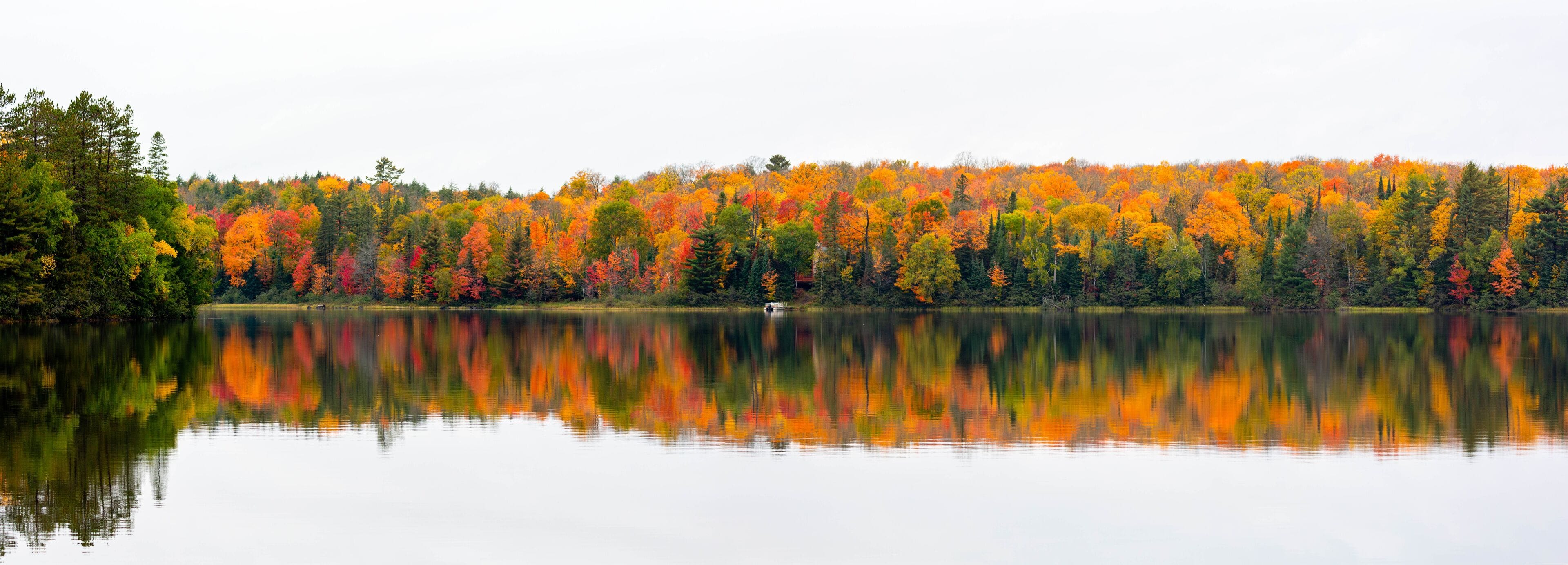 Colorful autumn trees on lake of the Falls in Mercer, Wisconsin