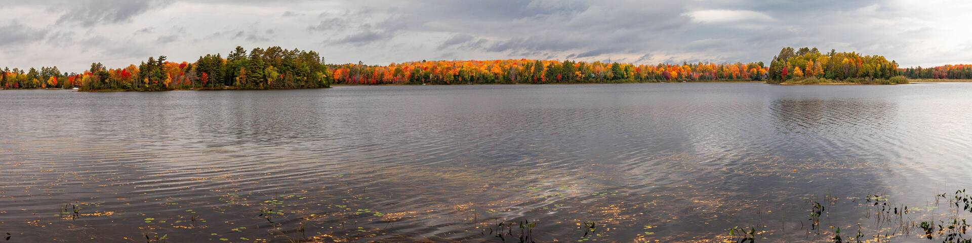 Colorful autumn trees on lake of the Falls in Mercer, Wisconsin