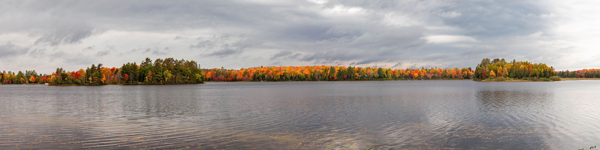 Colorful autumn trees on lake of the Falls in Mercer, Wisconsin