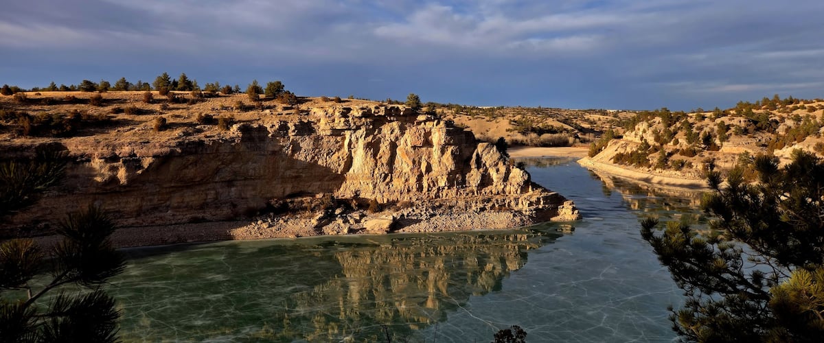 A river winding through a rocky canyon with sparse vegetation.