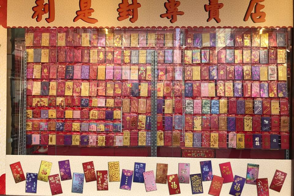 A store window display with various colorful greeting cards and envelopes.