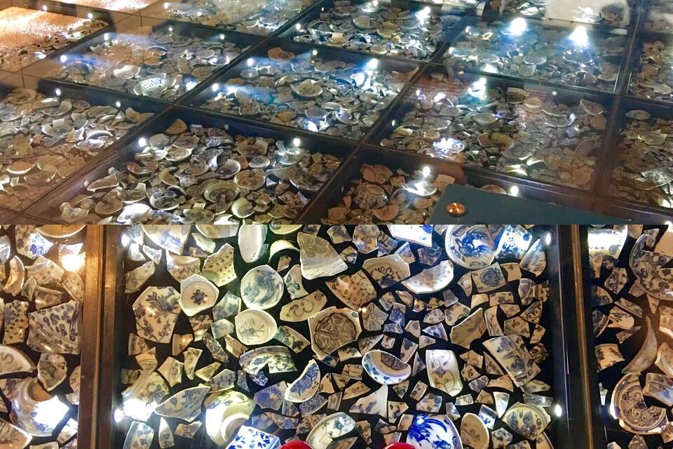 A display of ceramic dishes in a museum.