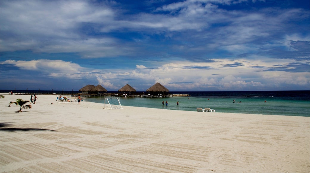 Juan Dolio which includes island images, a luxury hotel or resort and a sandy beach