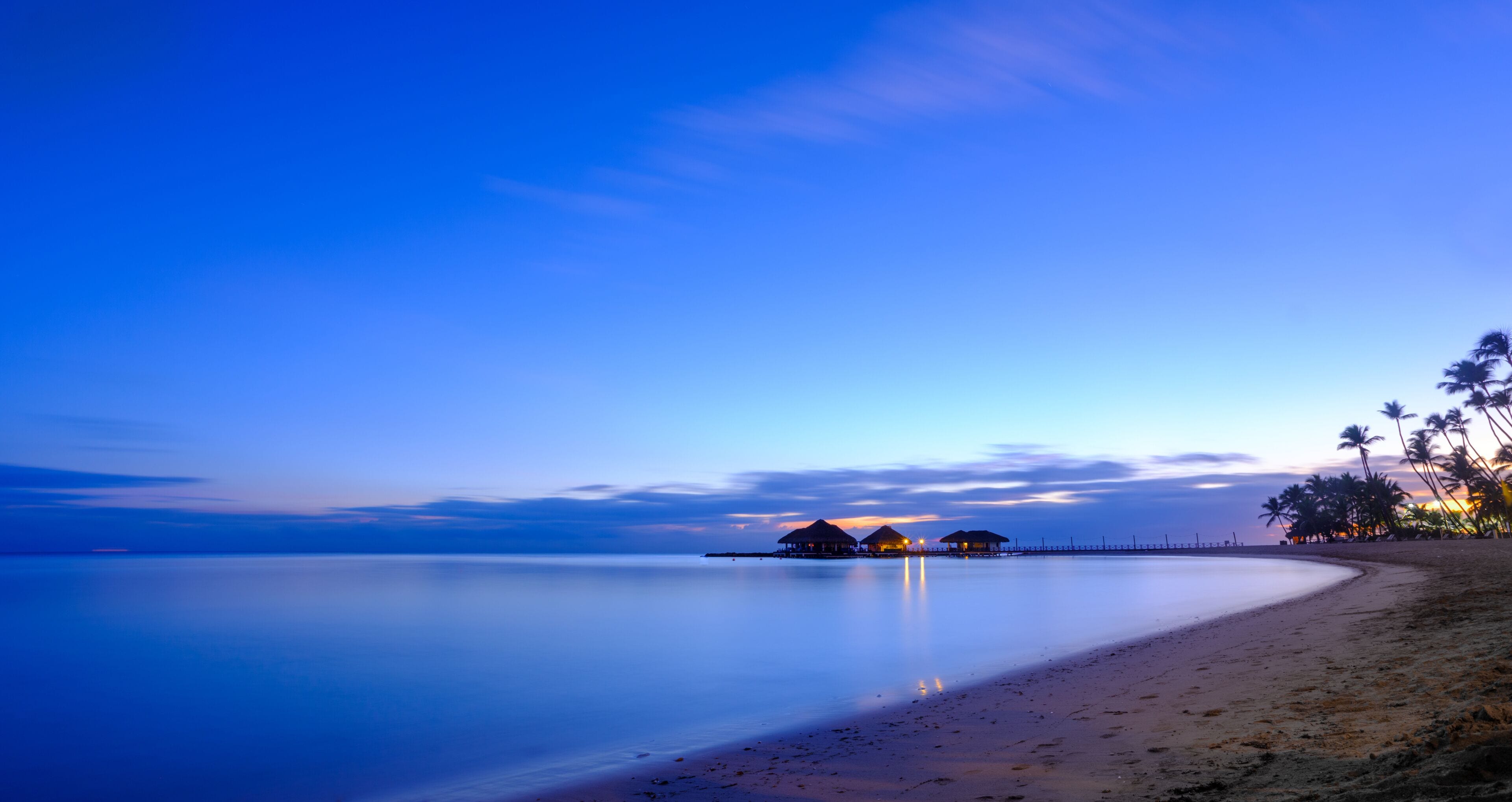 Time-lapse of sunrise over Caribbean beach with huts.