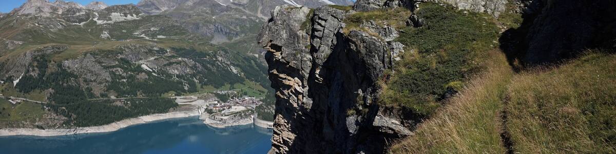 Cliff and lake Lac du Chevril in Tignes.