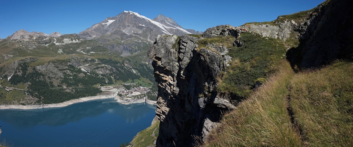Cliff and lake Lac du Chevril in Tignes.