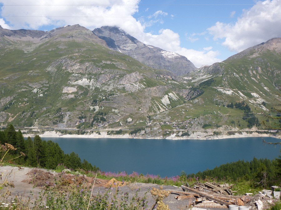 A mountainous landscape with a lake and a small settlement.
