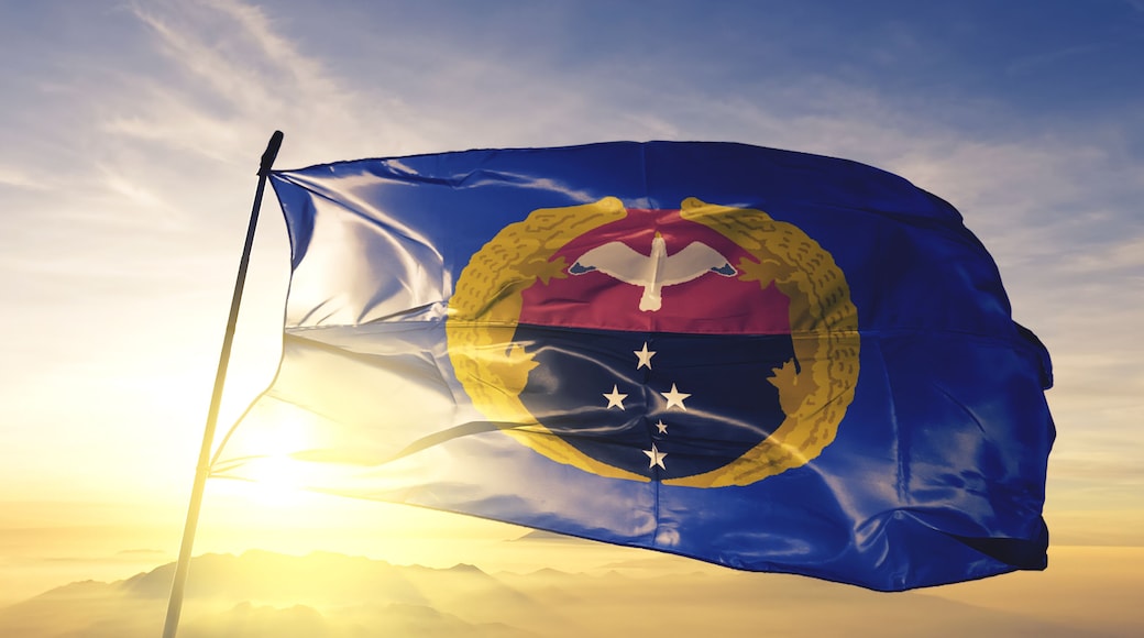 Gulf province of Papua New Guinea flag waving on the top sunrise mist fog