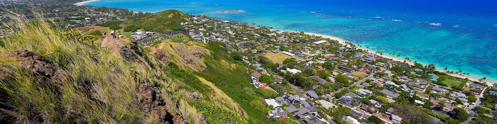 A coastal town with houses, a beach, and the ocean.