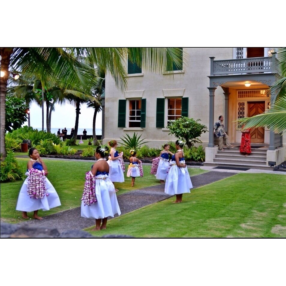 Flower girls are lined up for the wedding ceremony at the Hulihe'e Palace. 