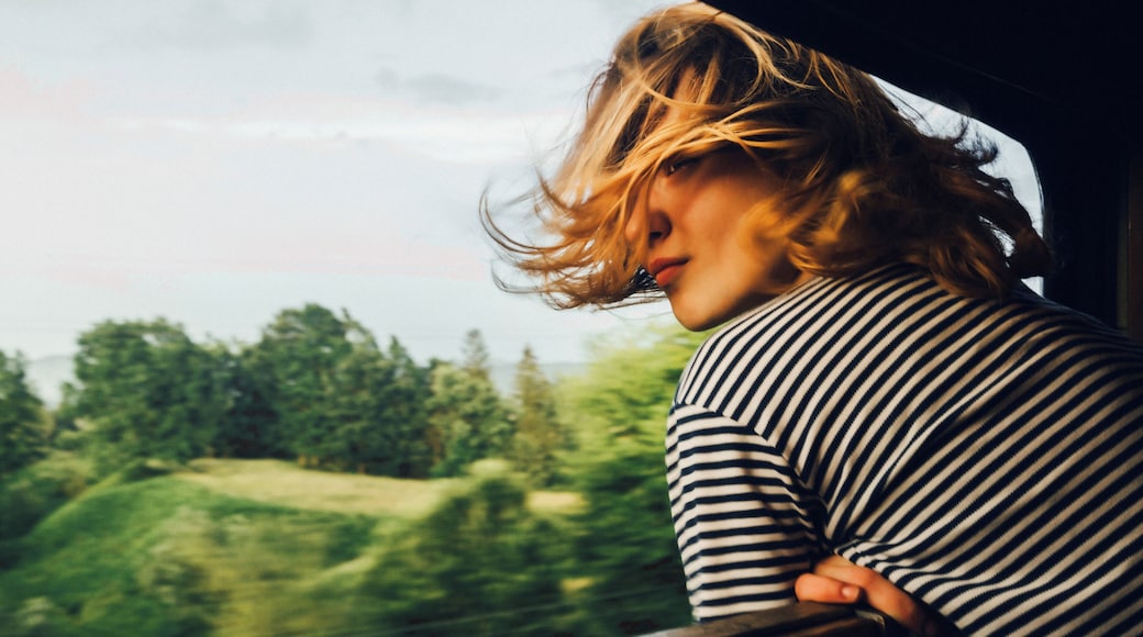 Caucasian woman looking at the view from train window