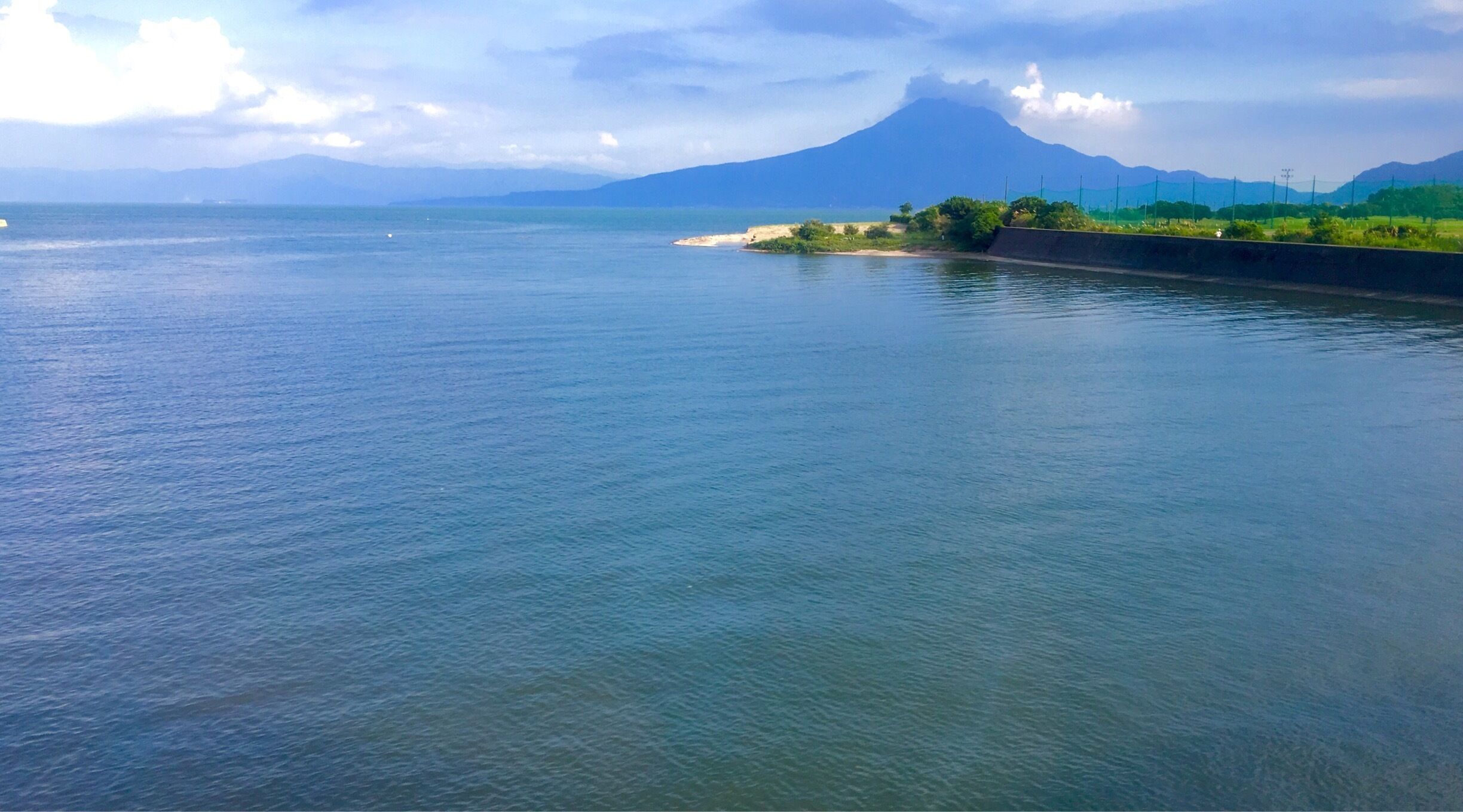 A calm river with a mountain in the background.