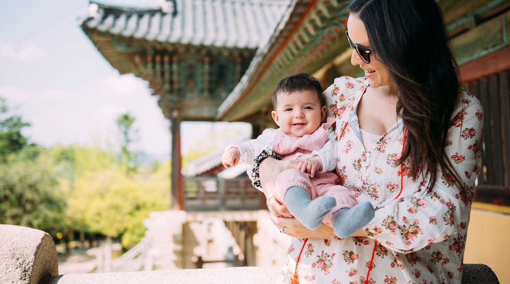South Korea, Gyeongju, woman traveling with a baby girl in Bulguksa Temple