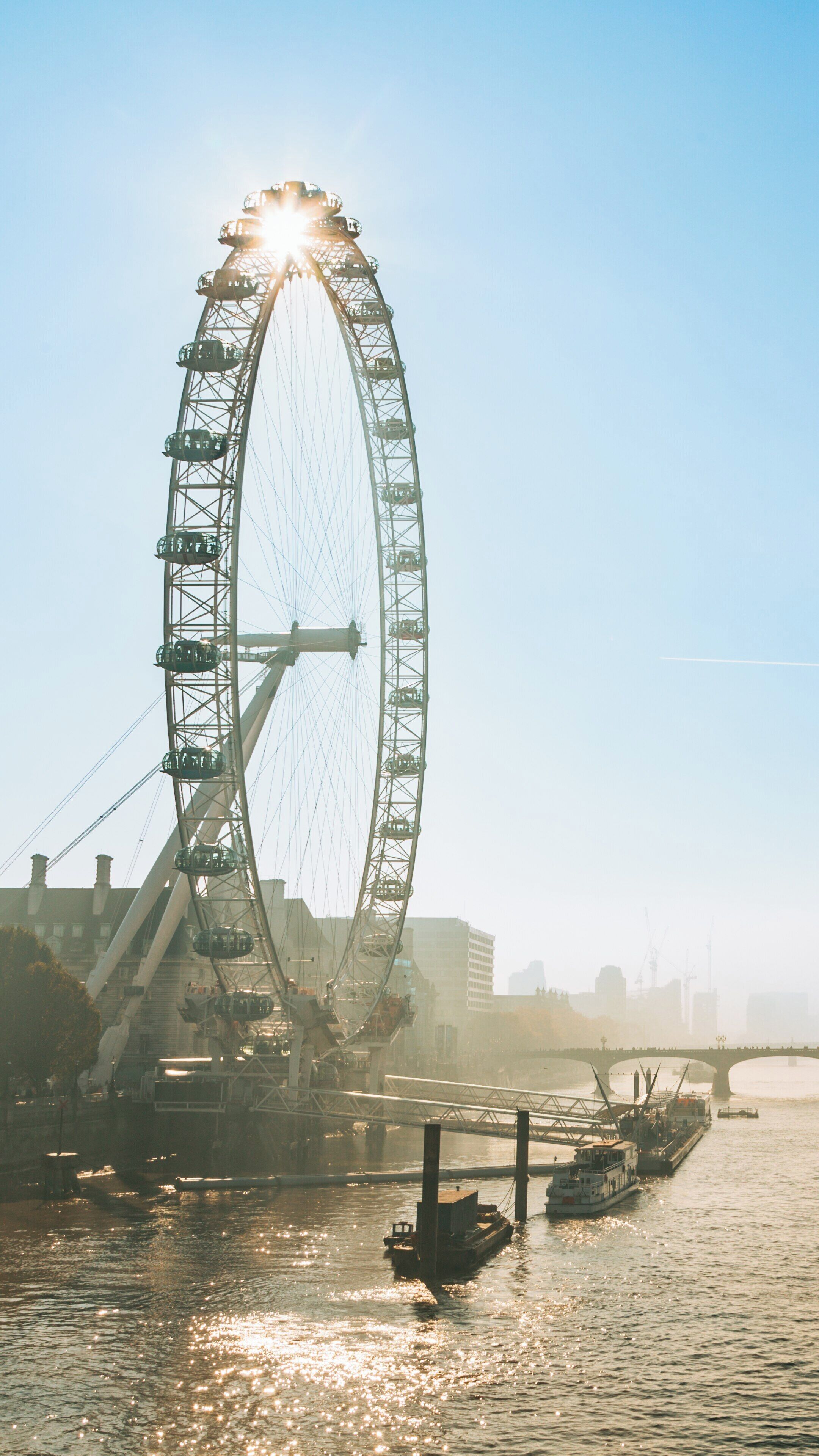 Stunning view of the London Eye and River Thames at sunset in Lambeth, London, England showcasing the iconic ferris wheel and surrounding architecture