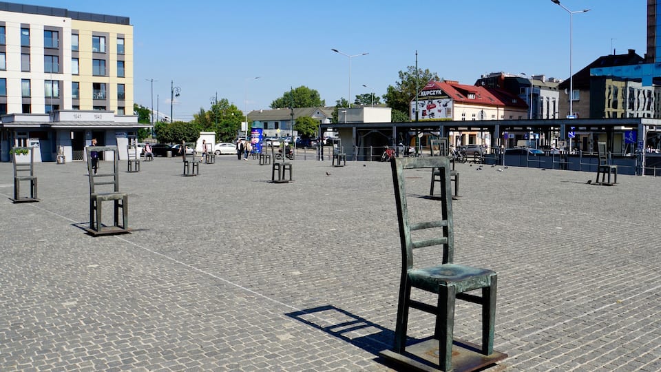 Some of the 70 empty metal chairs @ Plac Bohaterow Getta, Podgorze, Krakow, Poland (Sep 2019): these chairs have stood there since 2005 in memory of the fate that awaited many thousands of Jews deported from the Krakow Ghetto to the extermination camps during World War II.