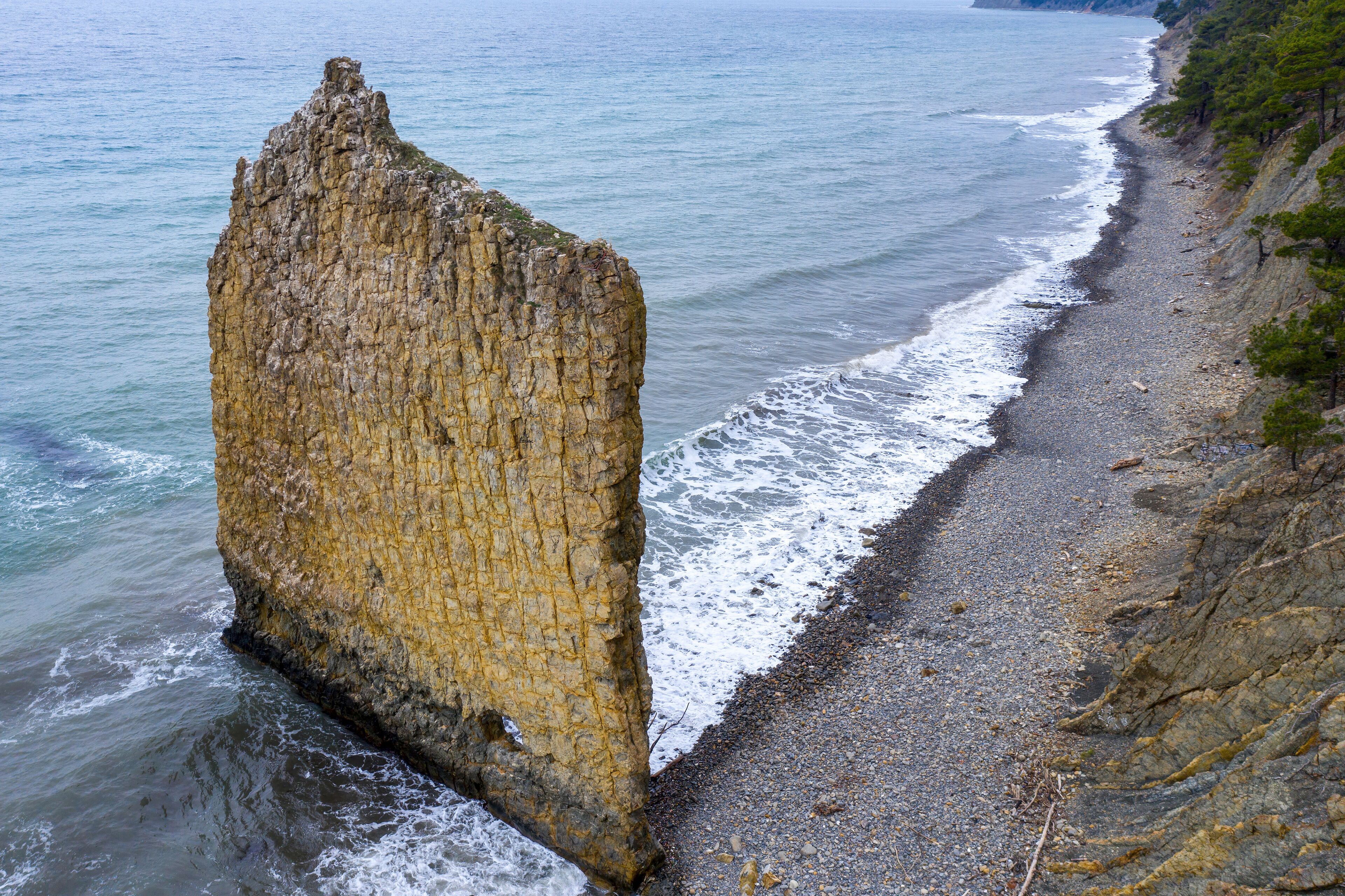 Drone view of Sail Rock (Parus Rock) and Black Sea on cloudy winter day. Praskoveevka, Krasnodar Krai, Russia.