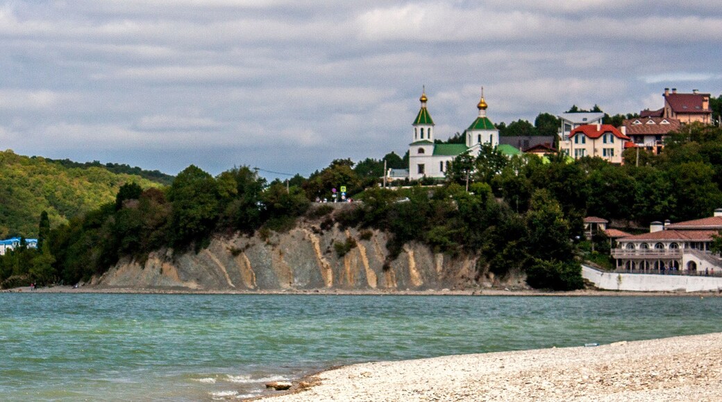 View of the church on the mountain. View of Lake Abrau-Durso from the shore. In the village of Abrau-Durso, on the mountain stands the Church of Blessed Xenia of Petersburg.