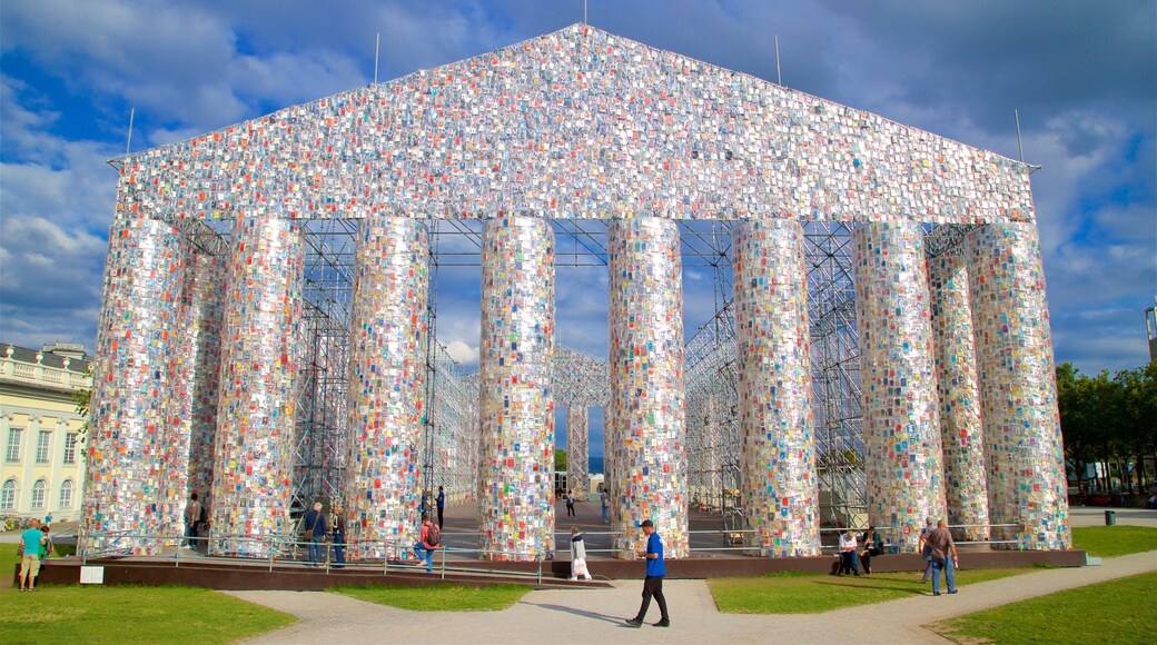 Kassel mostrando arte ao ar livre assim como um pequeno grupo de pessoas