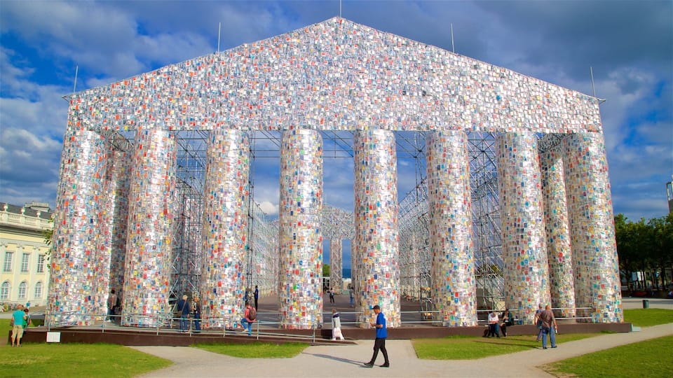 Kassel featuring outdoor art as well as a small group of people