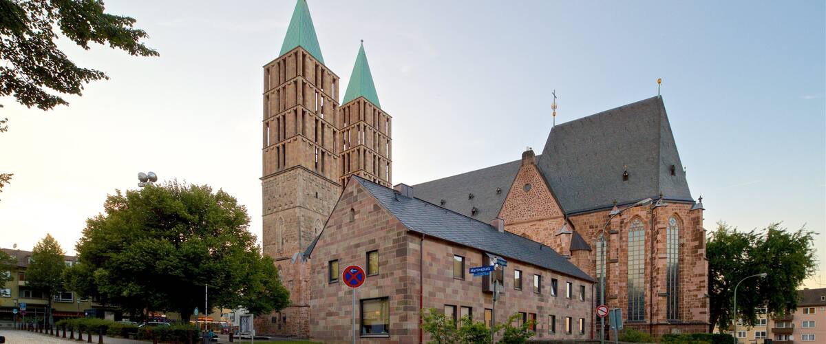 A historic church with a tall bell tower and a smaller spire.