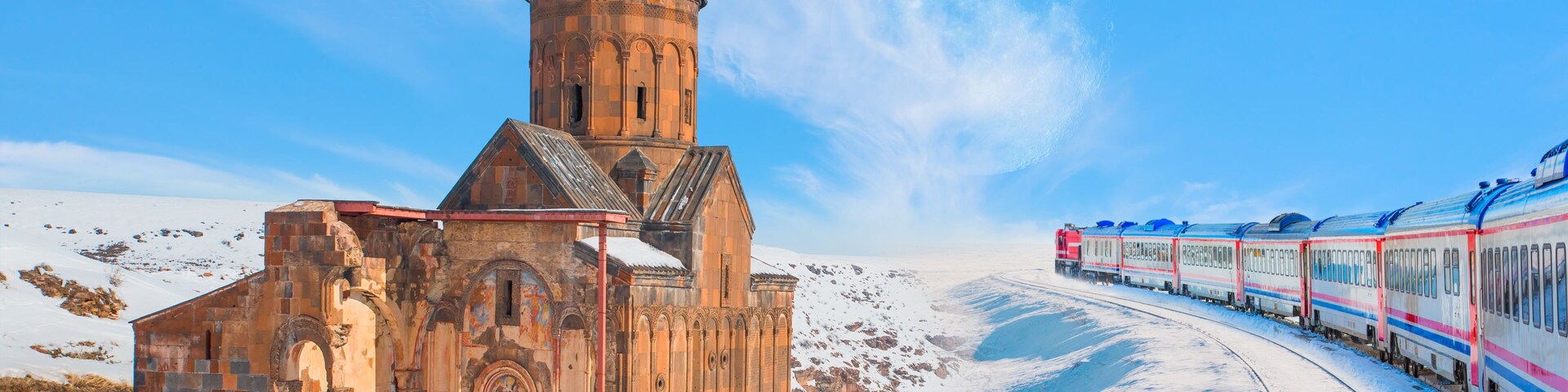 Red diesel train (East express) in motion at the snow covered railway platform - Ani Ruins, Ani is a ruined and uninhabited medieval Armenian city "Elements of this image furnished by NASA "