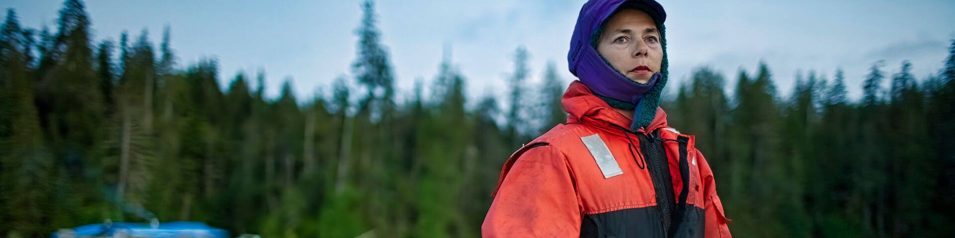 A woman drives a boat to Thorne Bay for supplies, Alaska, USA