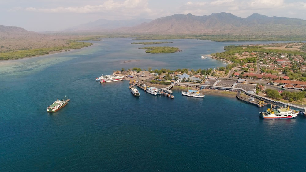 Aerial view ferry port gilimanuk with ferry boats, vehicles. Ferries transport vehicles and passengers in port. Port for departure from Bali to the island of Java.