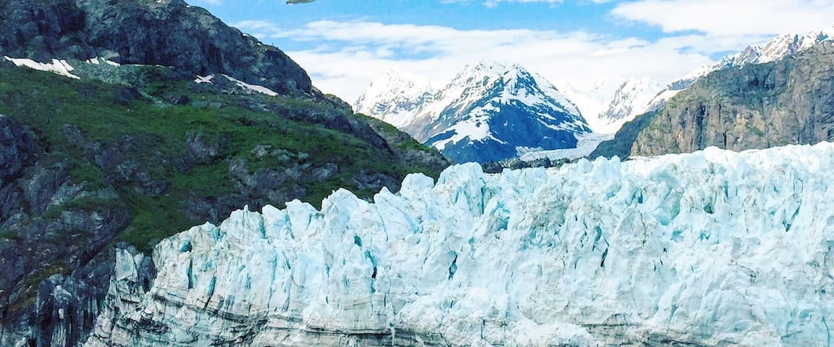 A glacier with a mountain in the background.