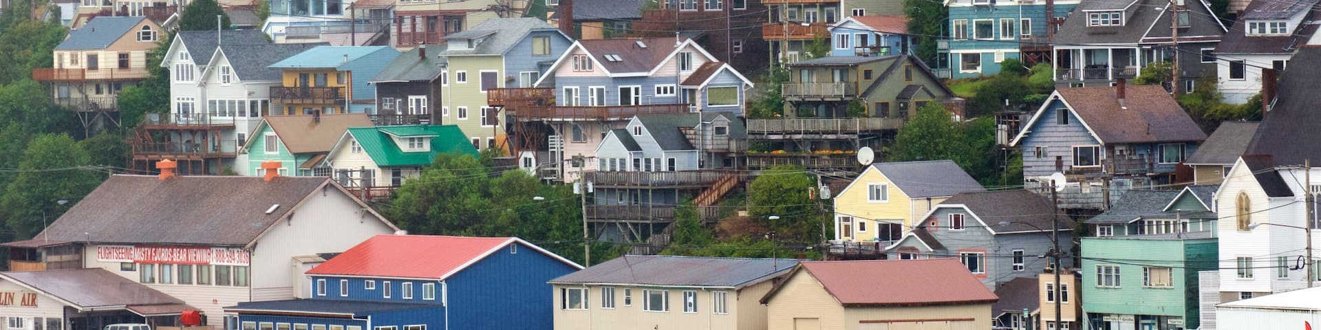 Alaska showing a bay or harbor, a small town or village and landscape views