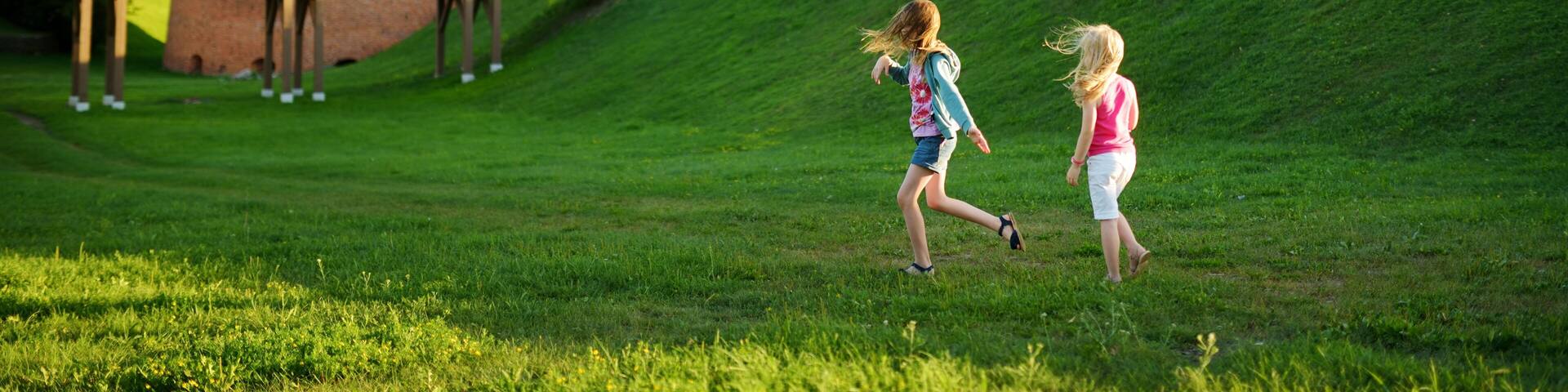 Two kids playing near Kaunas castle, situated in Kaunas, Lithuania