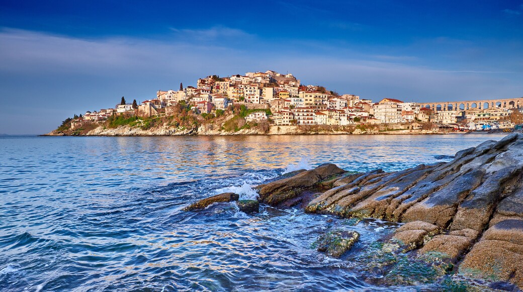 Incredibly romantic sunny spring seascape on Aegean Sea. Colorful morning view of Kavala city, eastern Macedonia, Greece, Europe..Beach view in Greece. Beautiful Kavala's view.